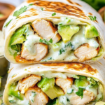 Grilled chicken avocado ranch burrito cut in half, revealing juicy chicken, creamy avocado, and melted cheese inside a toasted tortilla